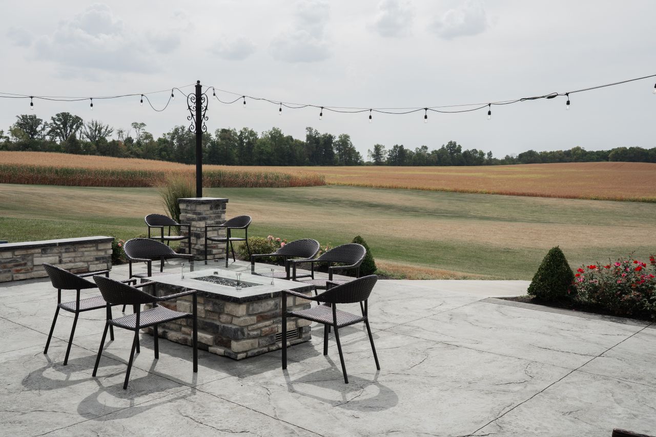 Services Charming outdoor patio with seating and countryside field view, perfect for relaxation.